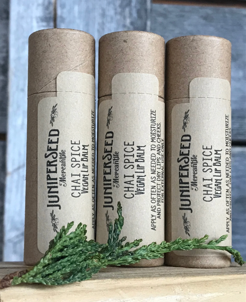 Three lip balms resting next to each other on a table 