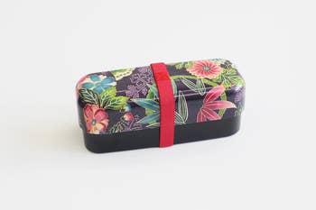 the long bento box with a colorful kimono-like pattern and red elastic band