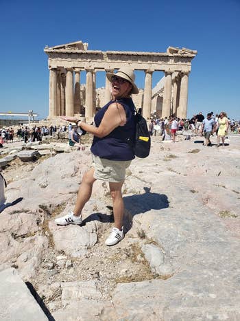 Tourist in a casual outfit with anti theft backpack in front of the parthenon in greece