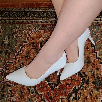 Reviewer wearing white heels