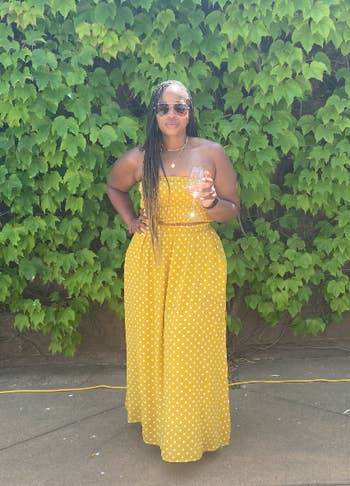 reviewer wearing dress set in yellow in front of a tall bush