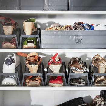 Organized closet shelves with assorted  shoes, including sandals, sneakers, and heels, stored successful  stackable footwear  holders and a cloth  container  for accessories