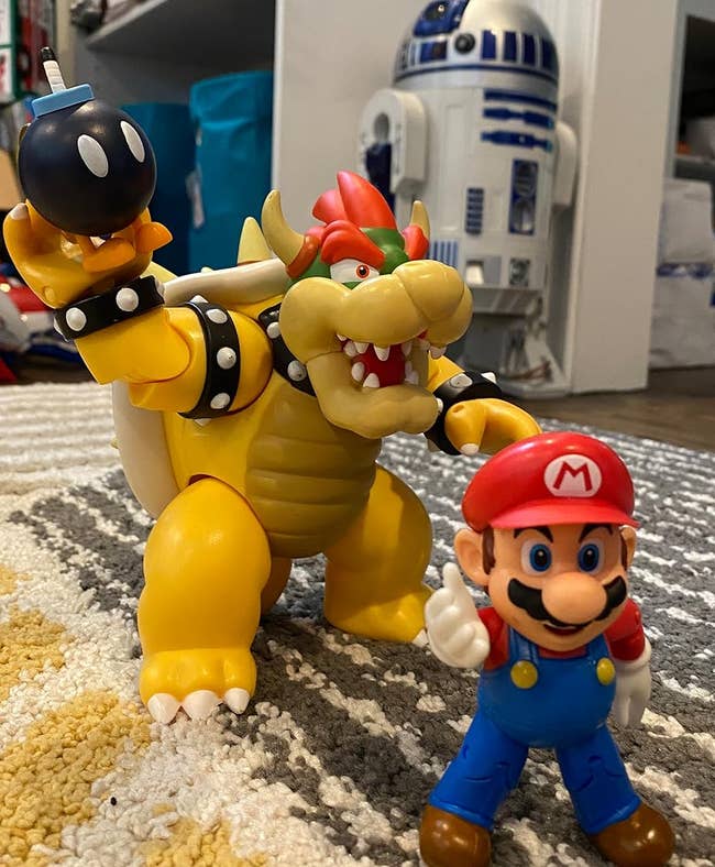 reviewers Bowser figure holding Bob-omb figure behind Mario figure