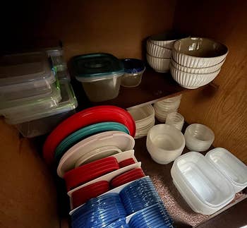 Various food storage containers organized inside a kitchen cabinet