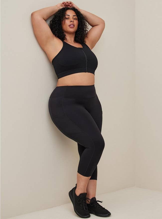 model wearing the cropped black leggings with side pockets
