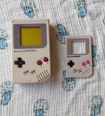a side by side of a real game boy next to the teether for comparison
