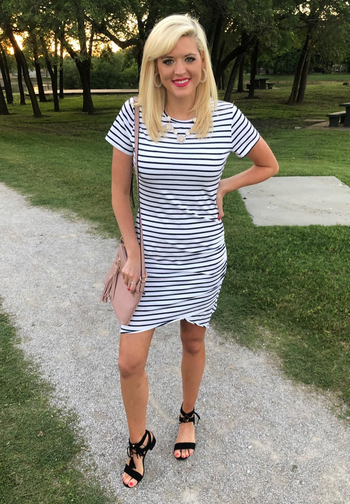reviewer in the black and white striped bodycon dress