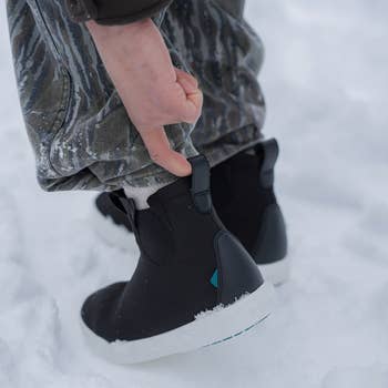 model wearing knit boots in the snow