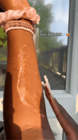 gif from the brand's tiktok showing the bronzey body butter rubbed into skin