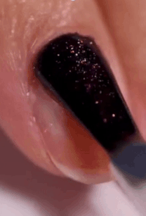 Nail creation brushwood applying acheronian glitter polish connected a fingernail, showcasing manicure technique