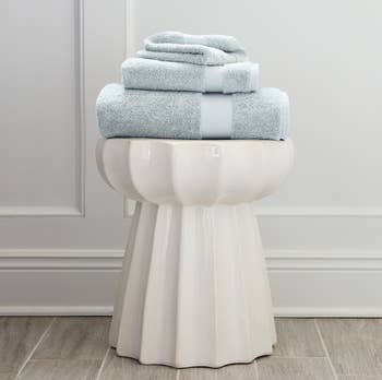 a stack of light blue plush towels 