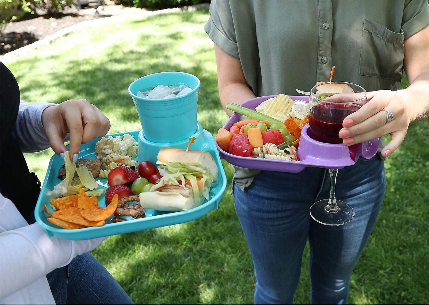 two people holding their plates with cups inside the cupholder