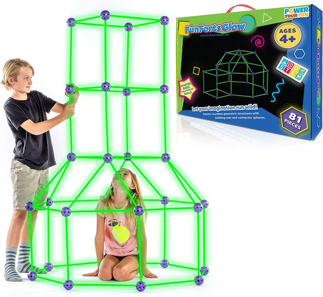 Two children models building a glow in the dark fort