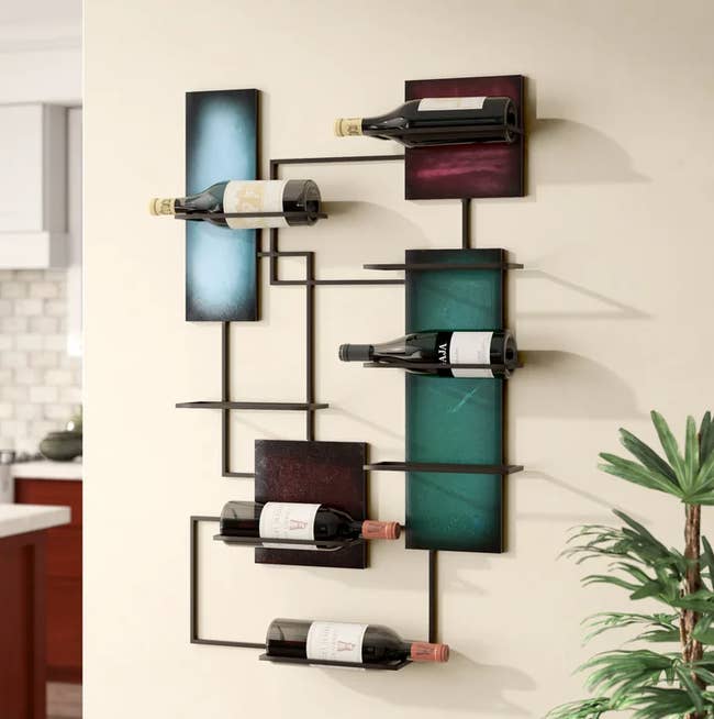 Image of the wall-mounted rack holding five bottles of wine