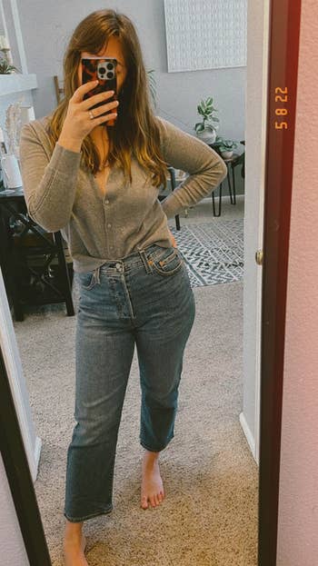 reviewer wearing the jeans in medium wash