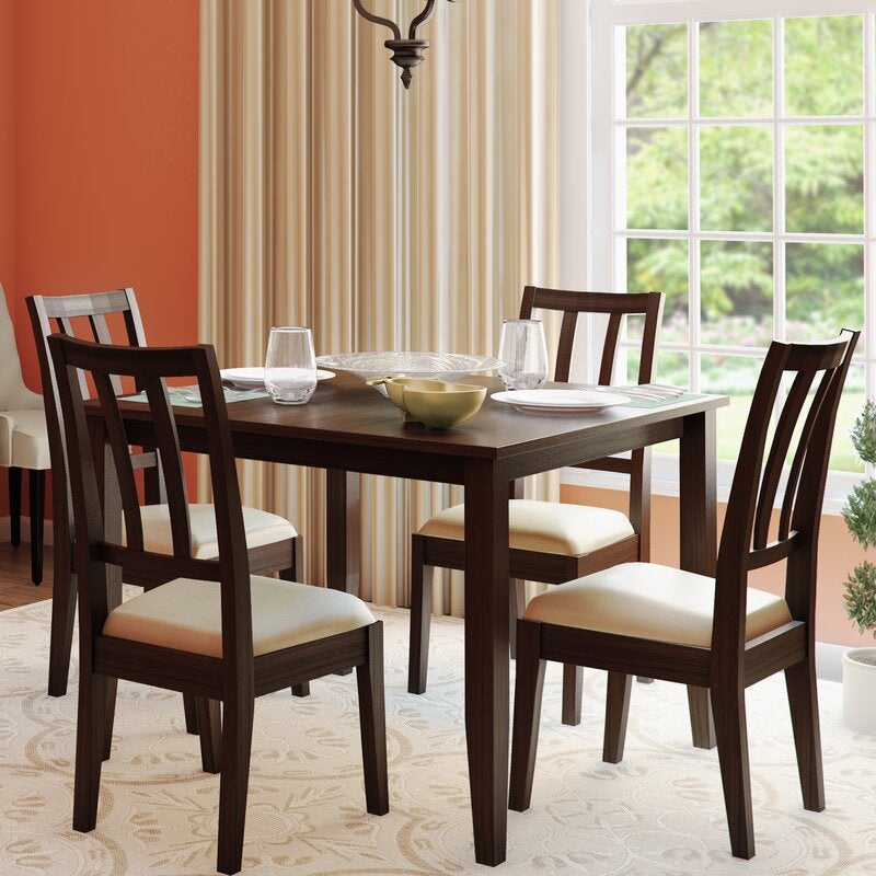 A dark brown set of chairs with a table