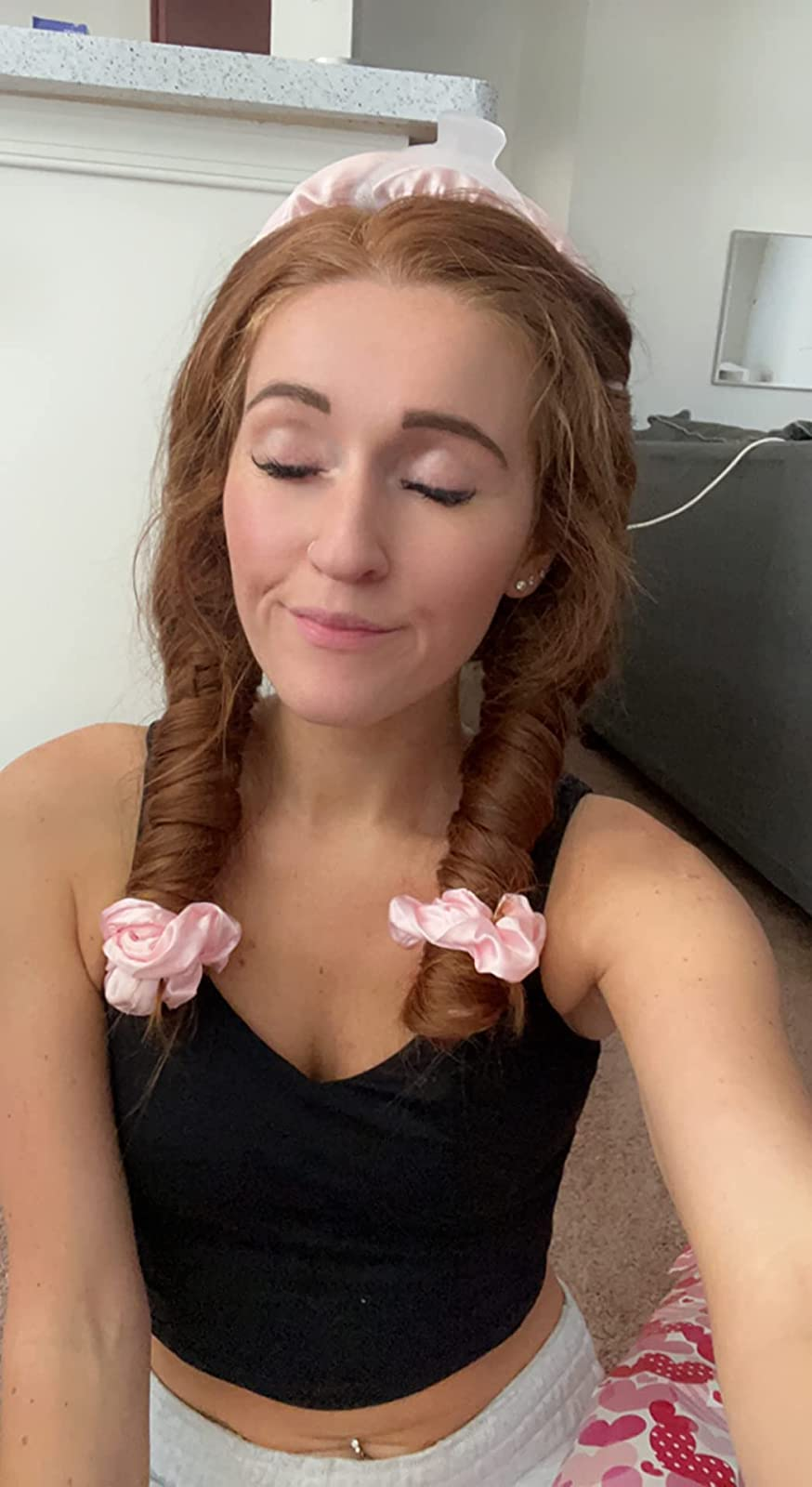 a reviewer with their hair wrapped in the curler before bed