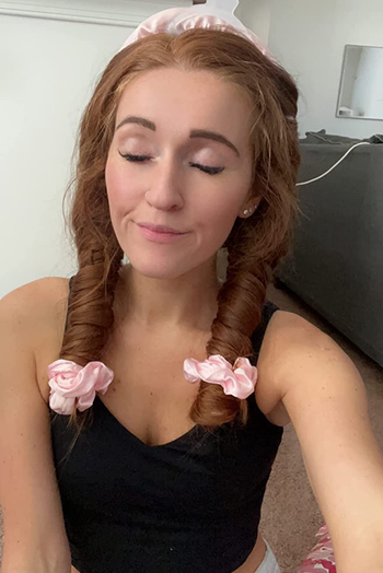 a reviewer with their hair wrapped in the curler before bed