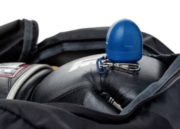blue pod with clip on top of a gym bag