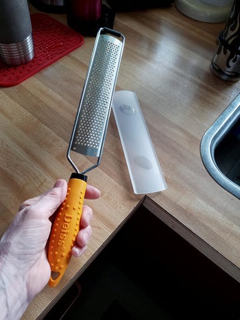 reviewer holding the handheld grater