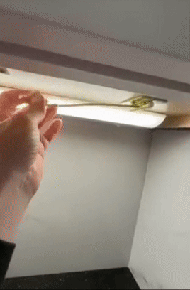 banana clip being stored and pulled down   from furniture  to clasp  bananas 