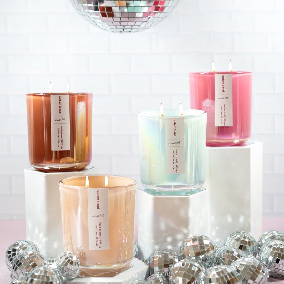 various different candles on pedestals surrounded by disco balls