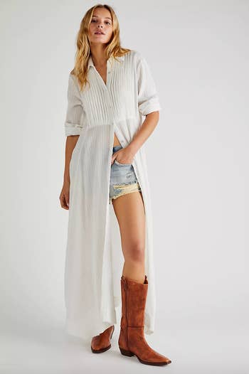 model wearing white maxi dress with slit and cowboy boots