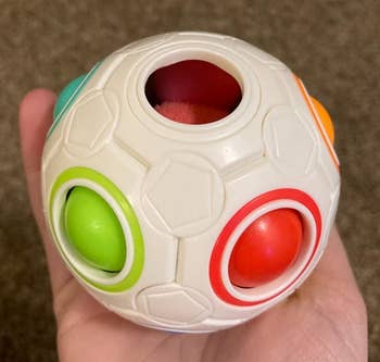 Reviewer holding the white fidget ball