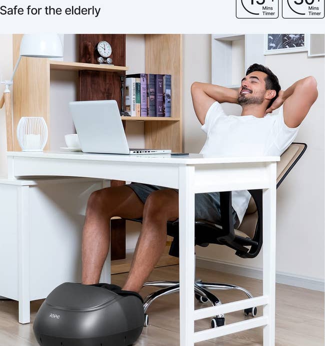 model using the foot massager while sitting at a desk