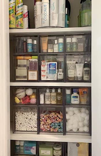 reviewer's closet full of the stackable drawers holding a variety of cosmetics, medicines, and other bathroom essentials