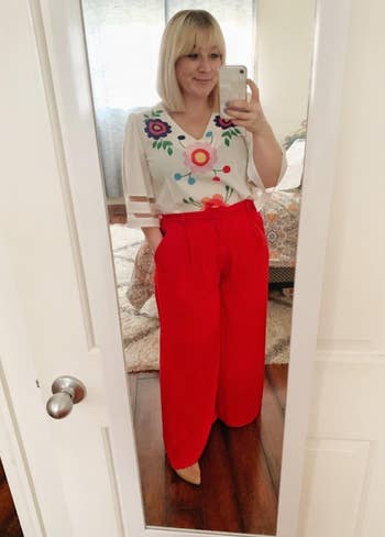 reviewer in red wide leg pants