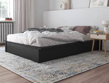 lifestyle photo of black platform bed in bedroom