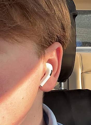 reviewer wearing an airpod in their ear