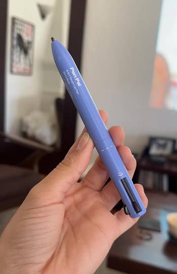 a reviewer holding the 4-in1 constitution pen