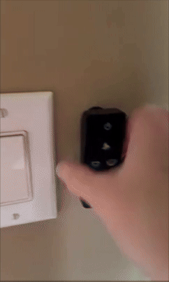 Hand turning a airy  power   connected  and disconnected  utilizing a distant    control, demonstrating a convenient location  automation gadget successful  use