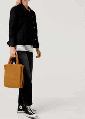 model with a tan sherpa bag