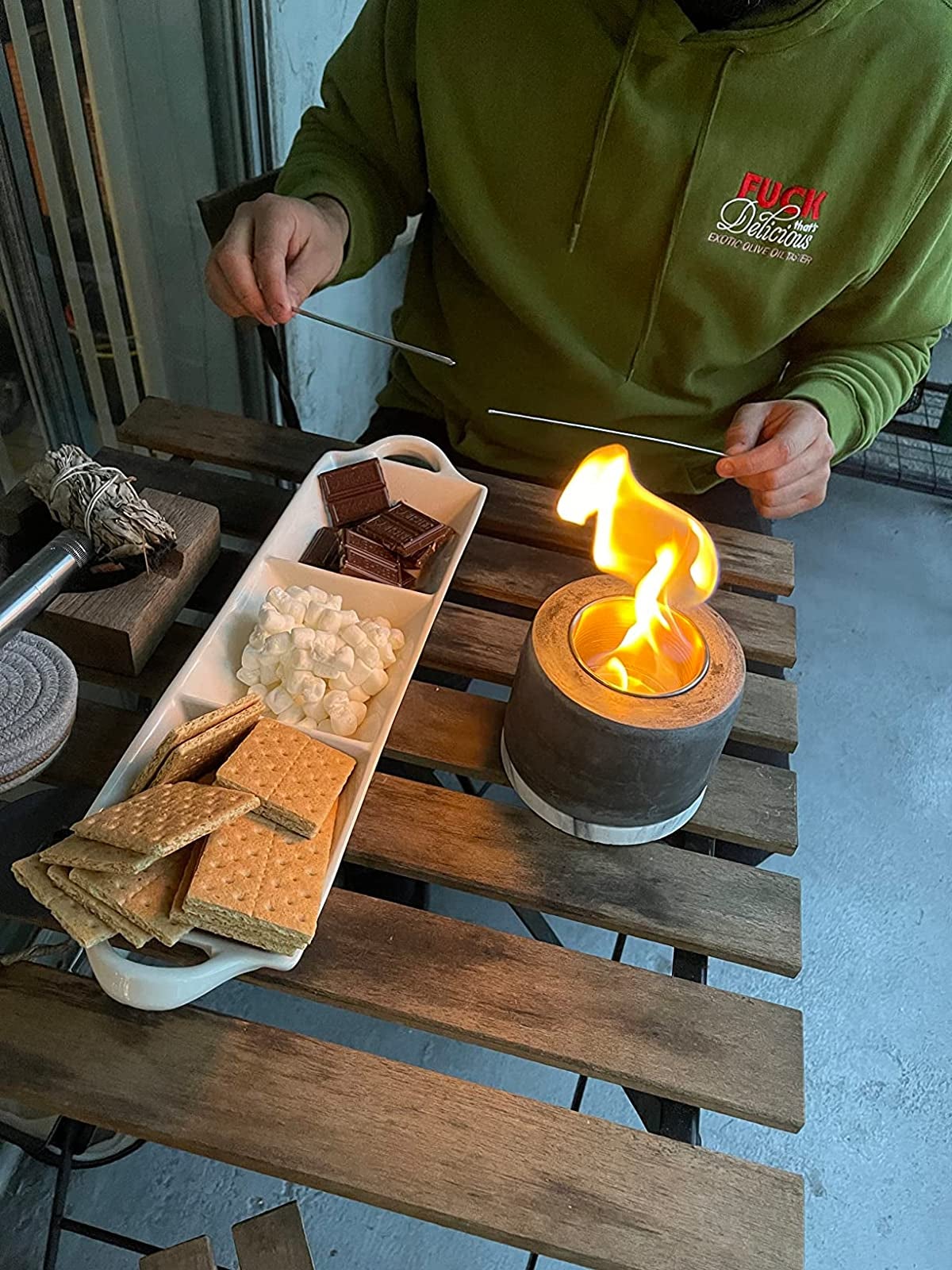 reviewer making s'mores over their table top fire pit