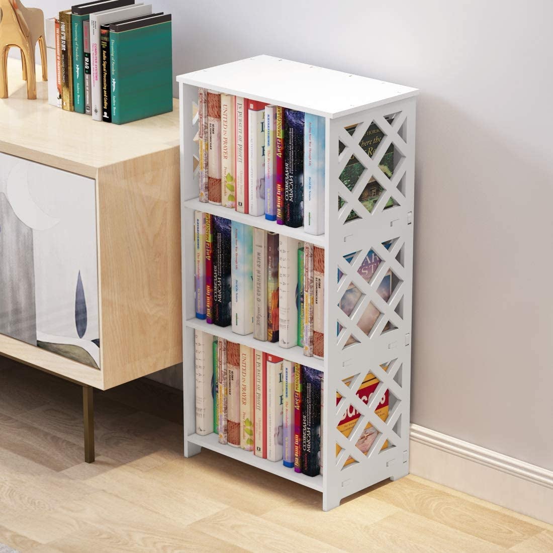 three-tier white bookcase with lattice detailing full of books