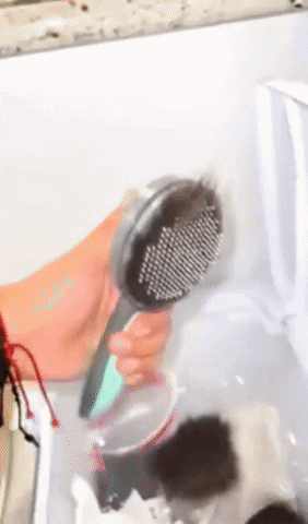 gif of a reviewer showing how easily the hair comes off the brush