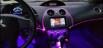 A reviewer's car with purple lit strips throughout