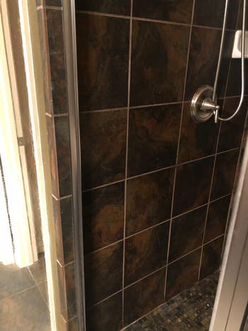 reviewer's tiled shower wall after cleaning with wet and forget