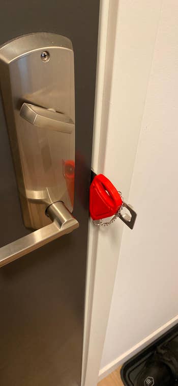 door lock tool secured in between door and threshold