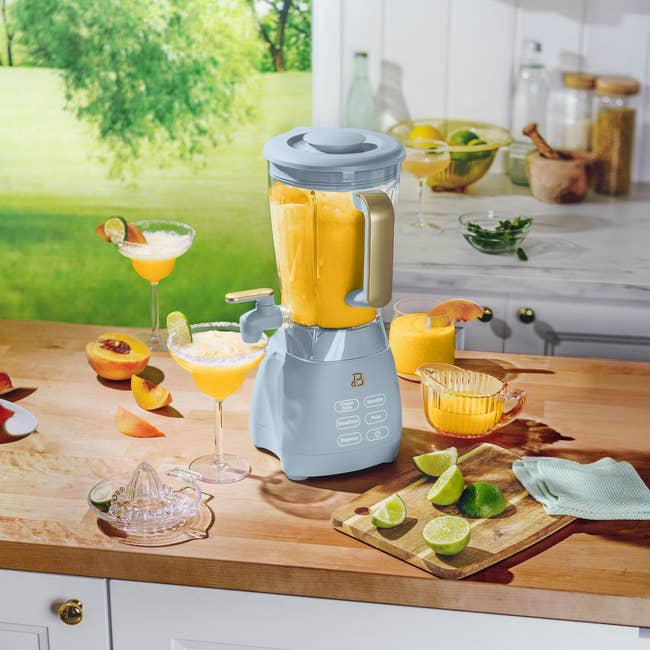 Blender connected  a room  antagonistic  making smoothies, surrounded by caller  citrus fruits and glasses with juice, acceptable   successful  a agleam  kitchen