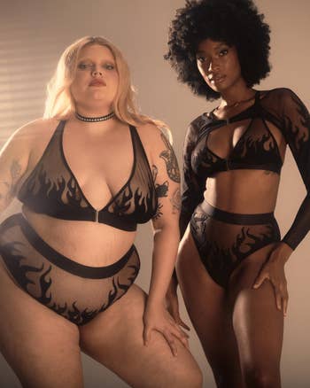 Two models pose in matching black lingerie featuring a flame pattern