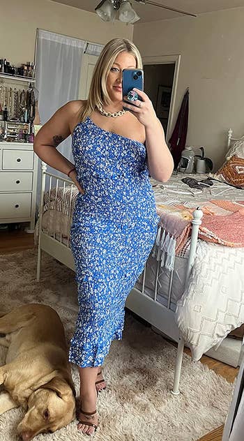 reviewer in the one-shoulder blue floral dress