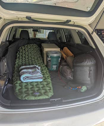 reviewer image of sleeping mat inside car trunk