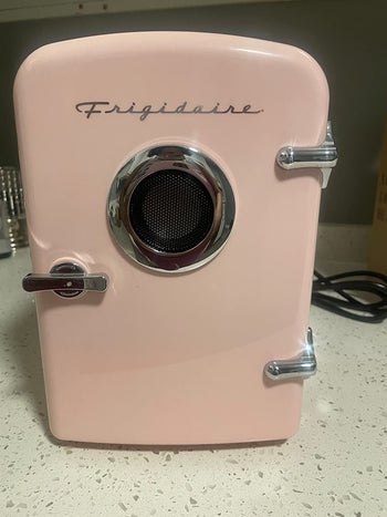 reviewer photo of a pink mini fridge with a built-in speaker