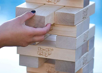 closeup of hand pulling block from tower