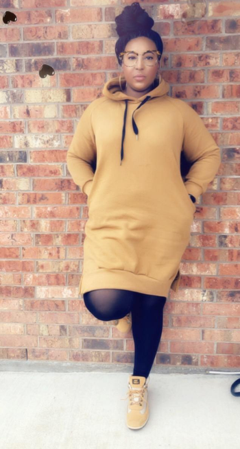 Daily News | Online News reviewer wearing the long yellow hoodie dress with black tights