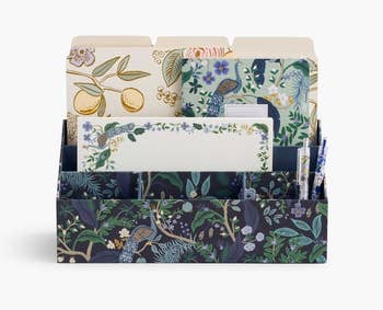 Decorative desk organizer with nature-inspired patterns holding stationary items